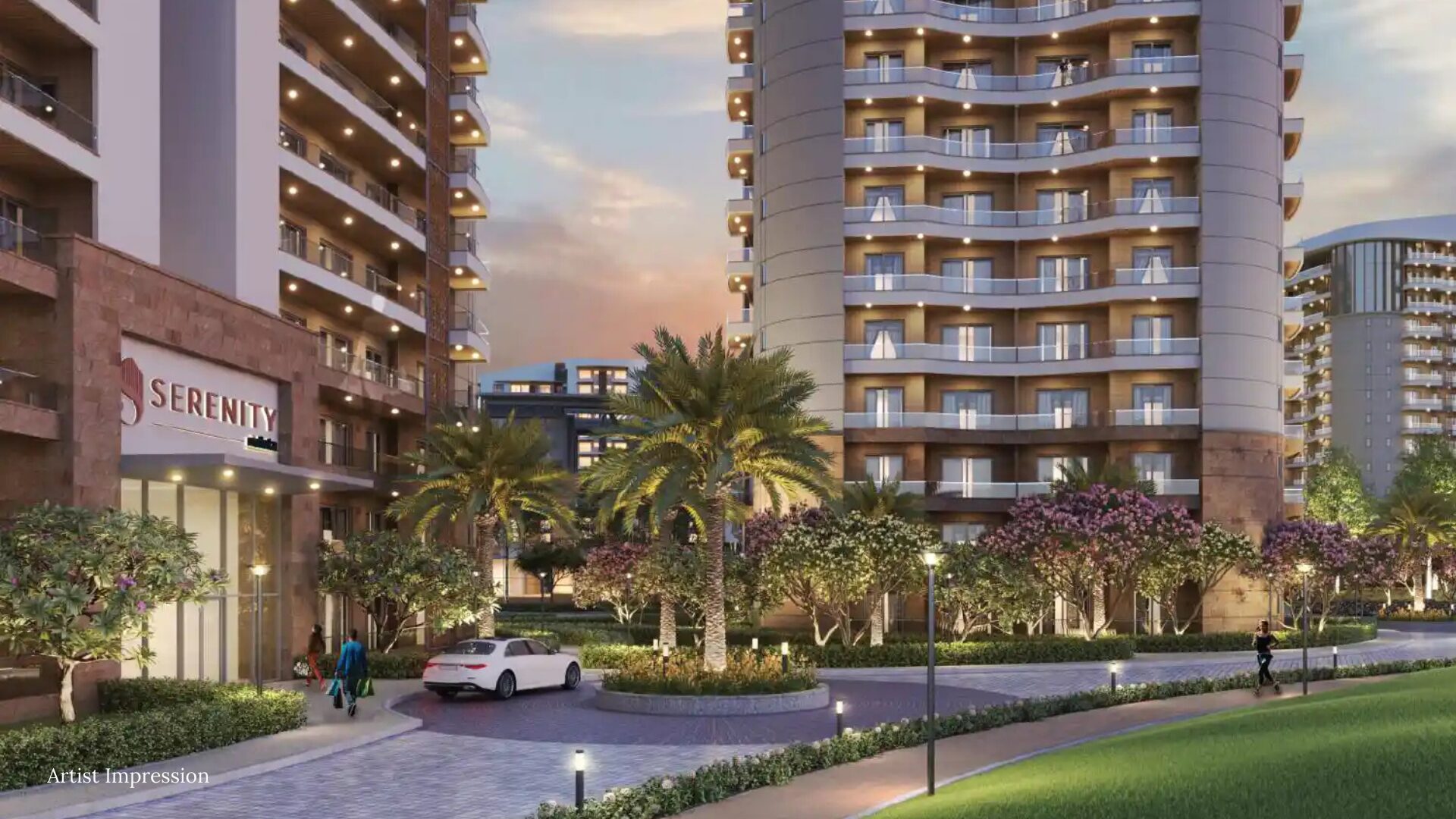 The main entrance of a residential tower at Rishita Serenity with a car pulling up.
